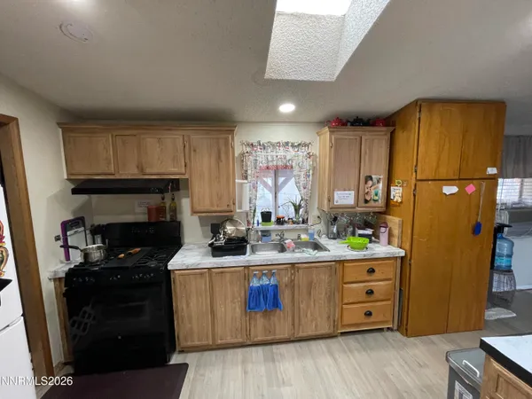 a kitchen with a sink appliances and cabinets