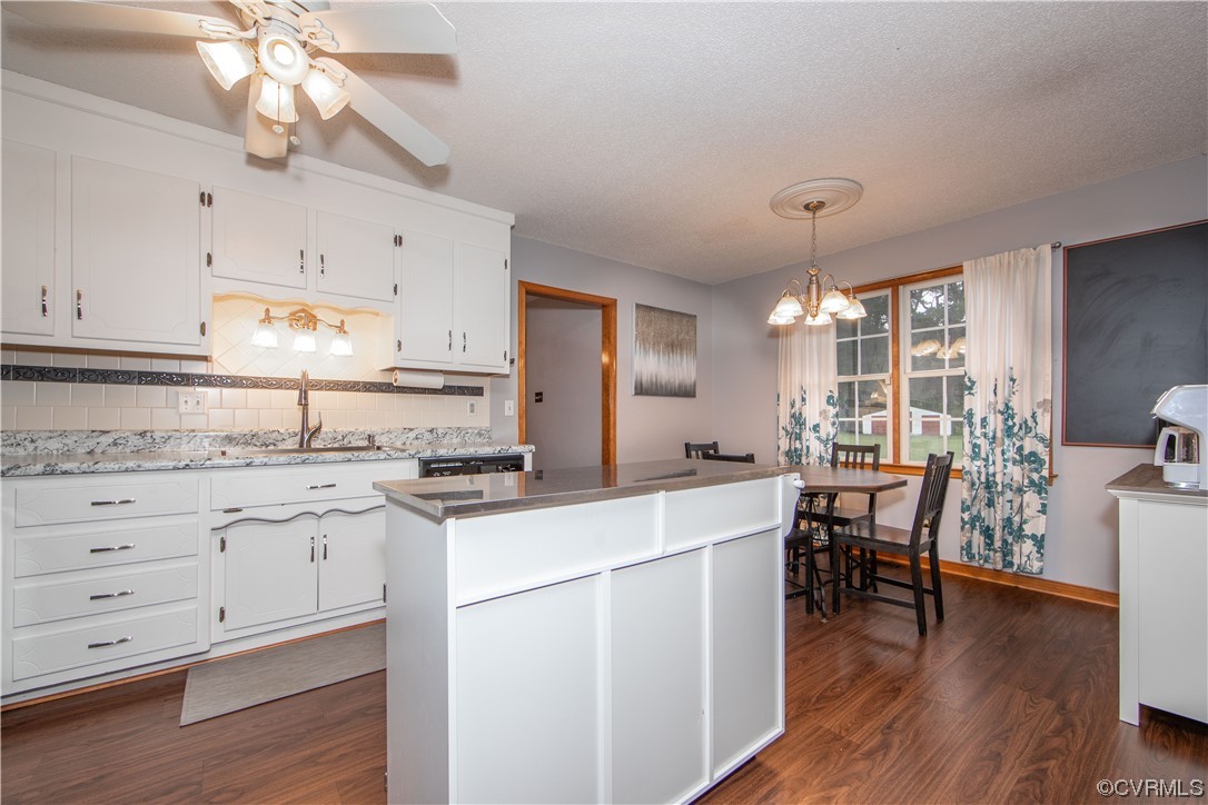 15803 Loving Union Road Disputanta, VA 23842 - Photo 13 of 39 a kitchen with a stove cabinets and wooden floor