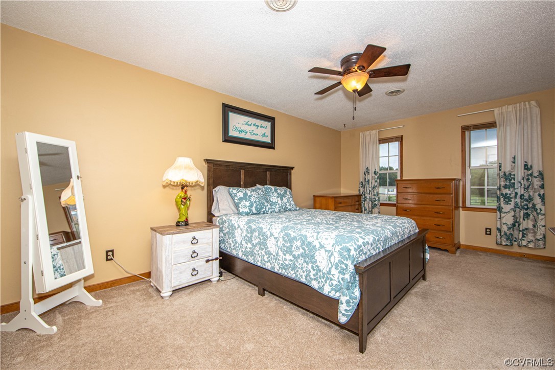 15803 Loving Union Road Disputanta, VA 23842 - Photo 25 of 39 a bedroom with a bed and a chandelier