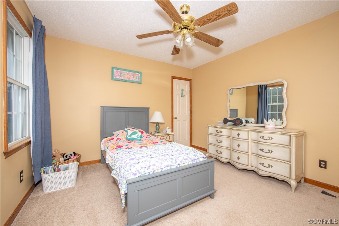 15803 Loving Union Road Disputanta, VA 23842 - Photo 33 of 39 a bedroom with a bed and a chandelier