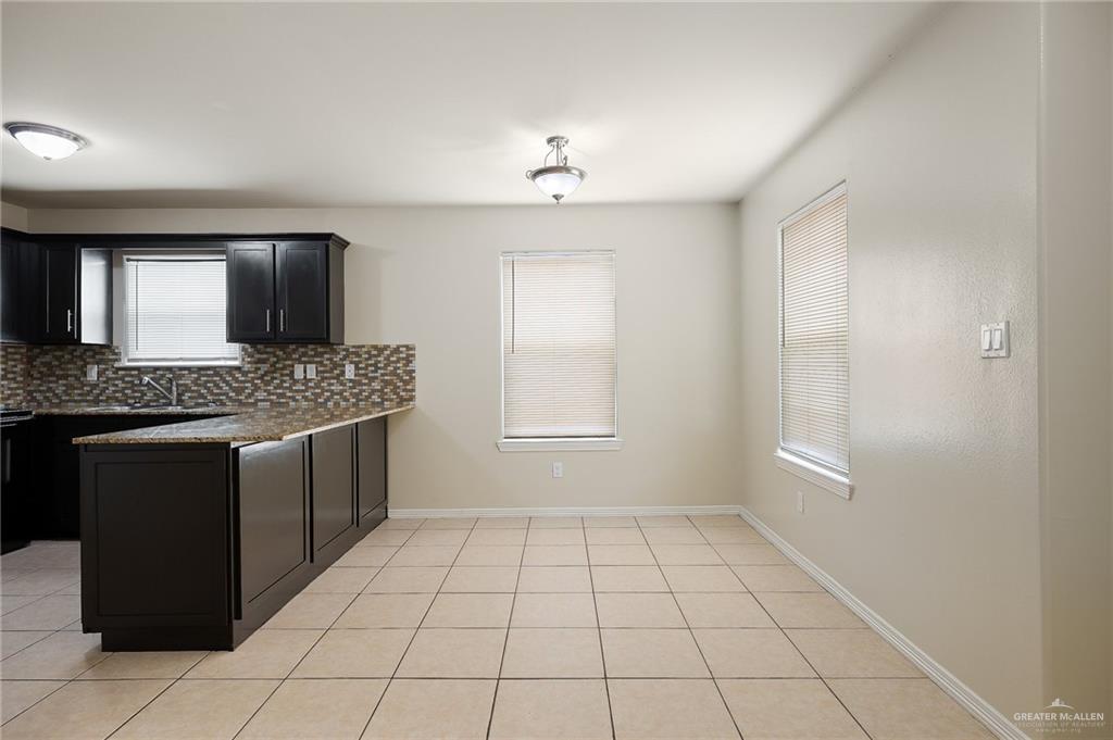 2305 West Mile 3 Road Mission, TX 78574 - Photo 13 of 20 a view of kitchen with granite countertop cabinets and a stove top oven