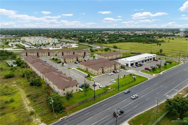 an aerial view of a houses with a yard