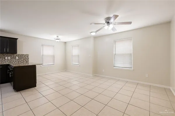 a kitchen with granite countertop a refrigerator and a sink