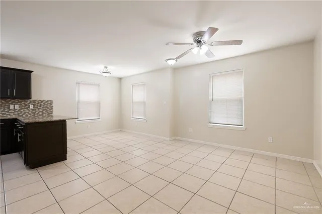 a kitchen with granite countertop a refrigerator and a sink
