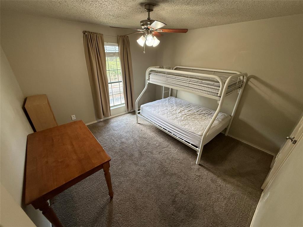 2401 Leon Street, Unit 209 Austin, TX 78705 - Photo 4 of 5 a bedroom with a bed window and dresser