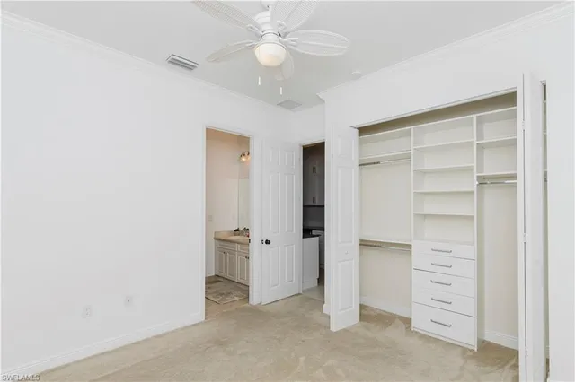 a view of walk in closet with cabinet