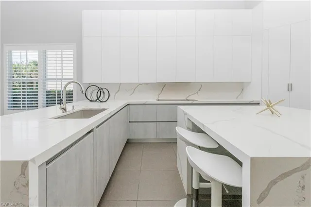 a kitchen with a sink and cabinets