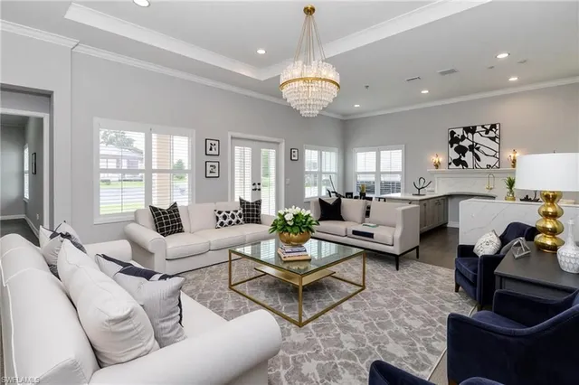 a living room with furniture potted plant and a chandelier