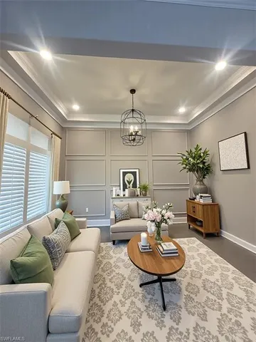a living room with furniture potted plant and a window