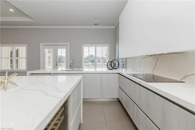 a kitchen with a sink and white cabinets