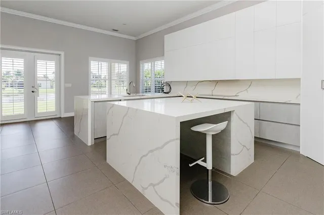 a kitchen with a sink a stove and cabinets