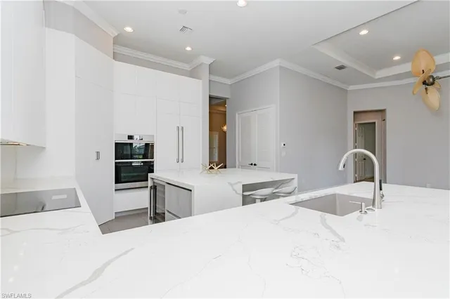 a bedroom with a bed and a large mirror on the dresser