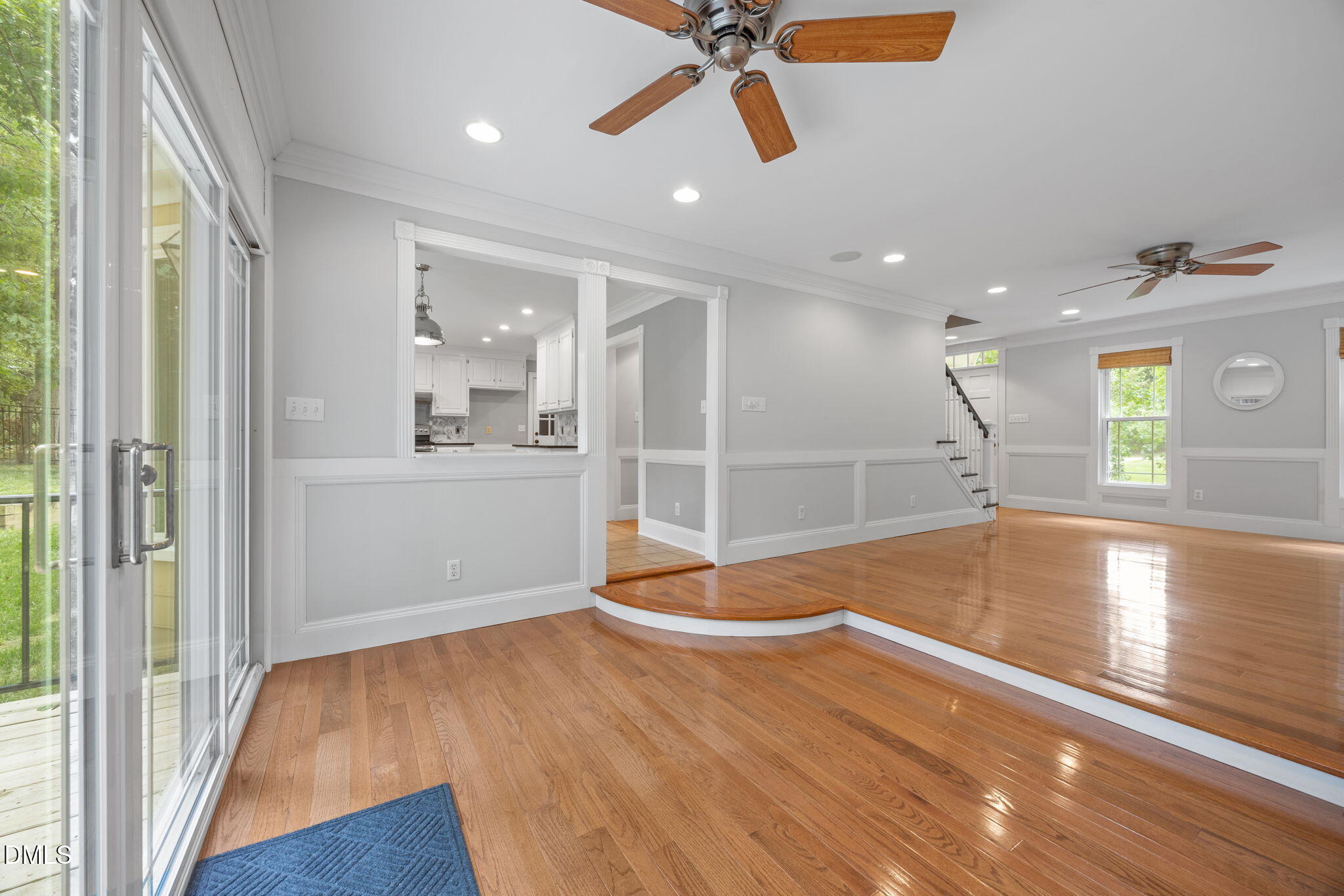 8221 Harps Mill Road Raleigh, NC 27615 - Photo 10 of 46 a view of a room with wooden floor and a ceiling fan
