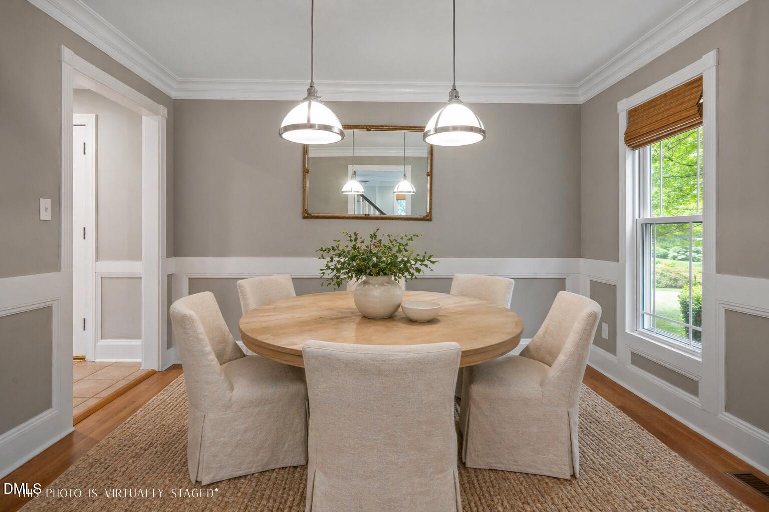8221 Harps Mill Road Raleigh, NC 27615 - Photo 12 of 46 a dining room with furniture a large window and wooden floor