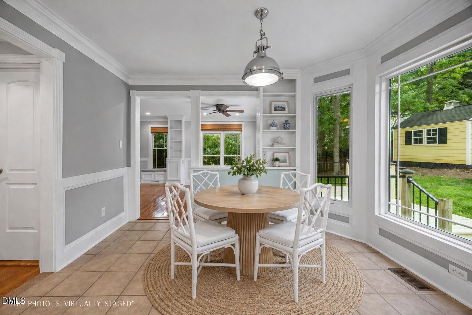 8221 Harps Mill Road Raleigh, NC 27615 - Photo 14 of 46 a dining room with furniture a chandelier and wooden floor