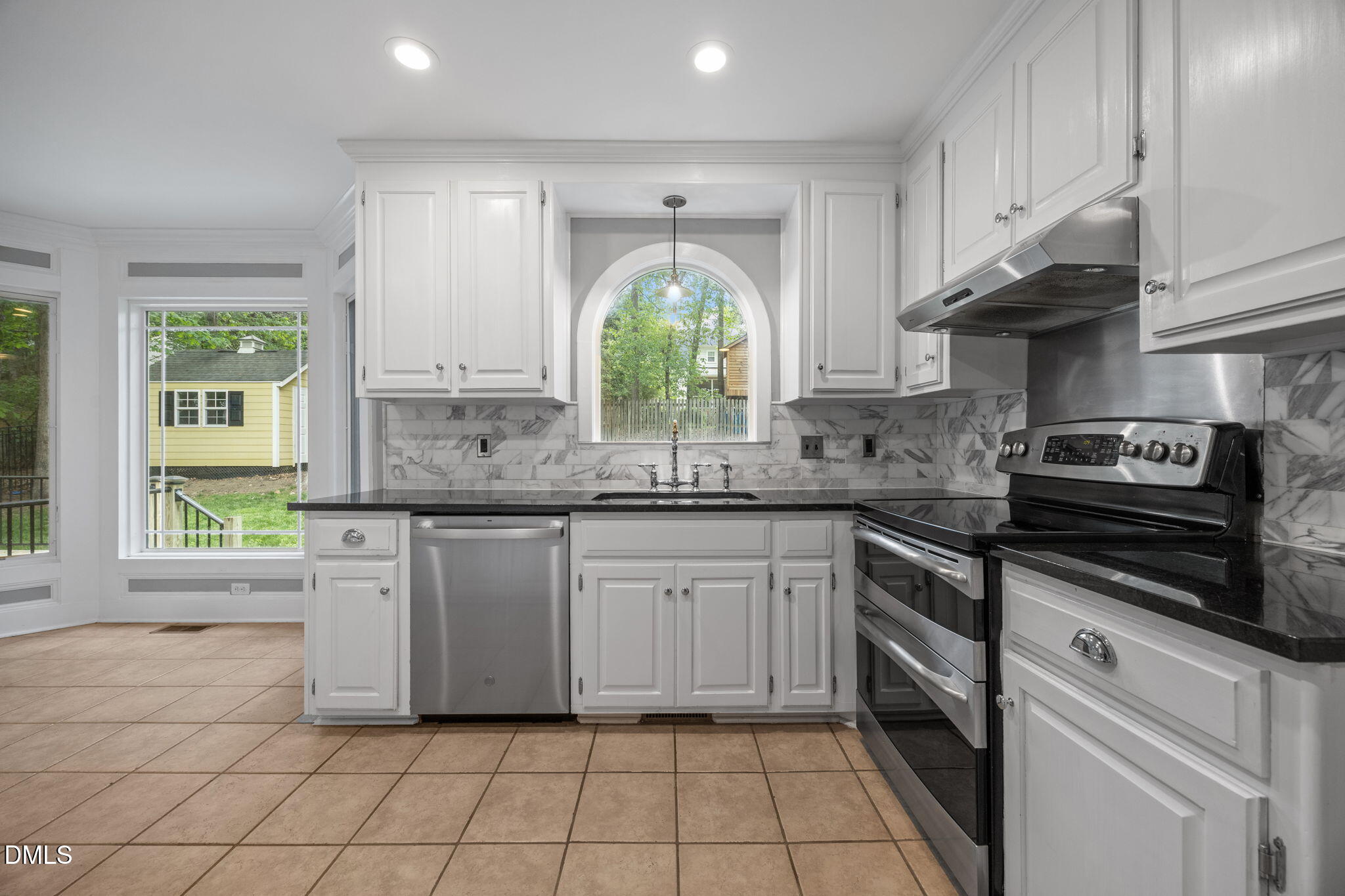 8221 Harps Mill Road Raleigh, NC 27615 - Photo 17 of 46 a kitchen with a white cabinets and window