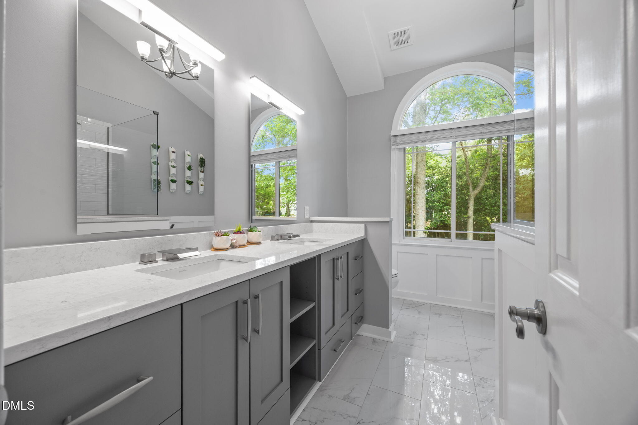 8221 Harps Mill Road Raleigh, NC 27615 - Photo 22 of 46 a view of bathroom with a sink and a mirror
