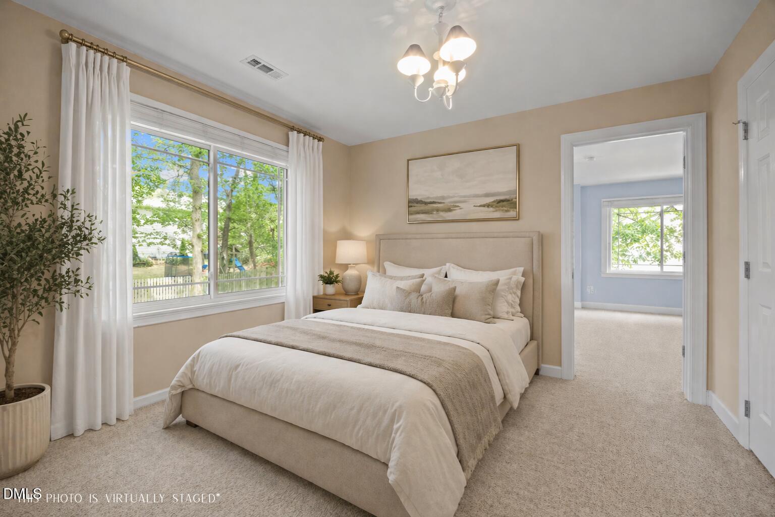 8221 Harps Mill Road Raleigh, NC 27615 - Photo 25 of 46 a bedroom with a large bed and a window