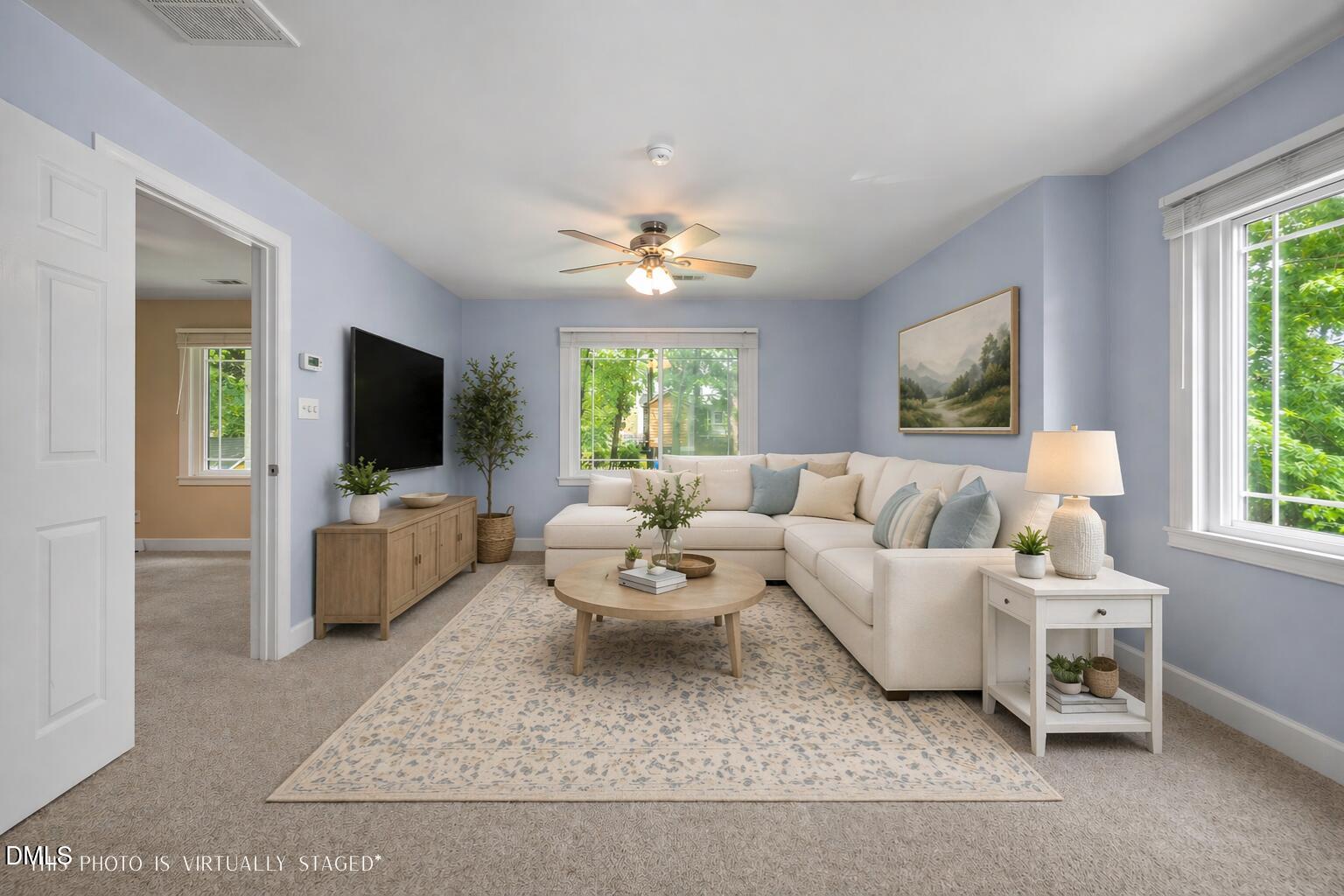 8221 Harps Mill Road Raleigh, NC 27615 - Photo 28 of 46 a living room with furniture and a flat screen tv