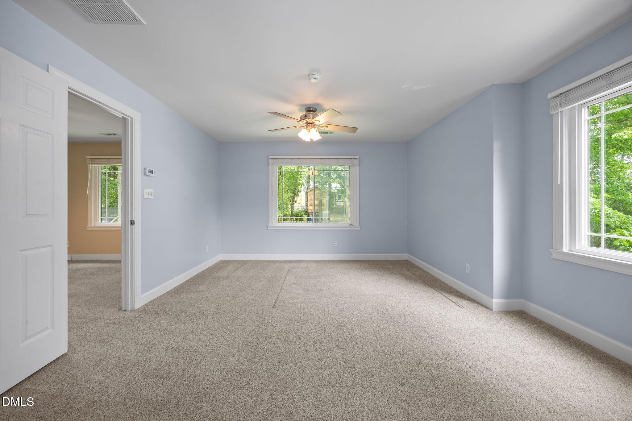 8221 Harps Mill Road Raleigh, NC 27615 - Photo 29 of 46 an empty room that has a window and a ceiling fan