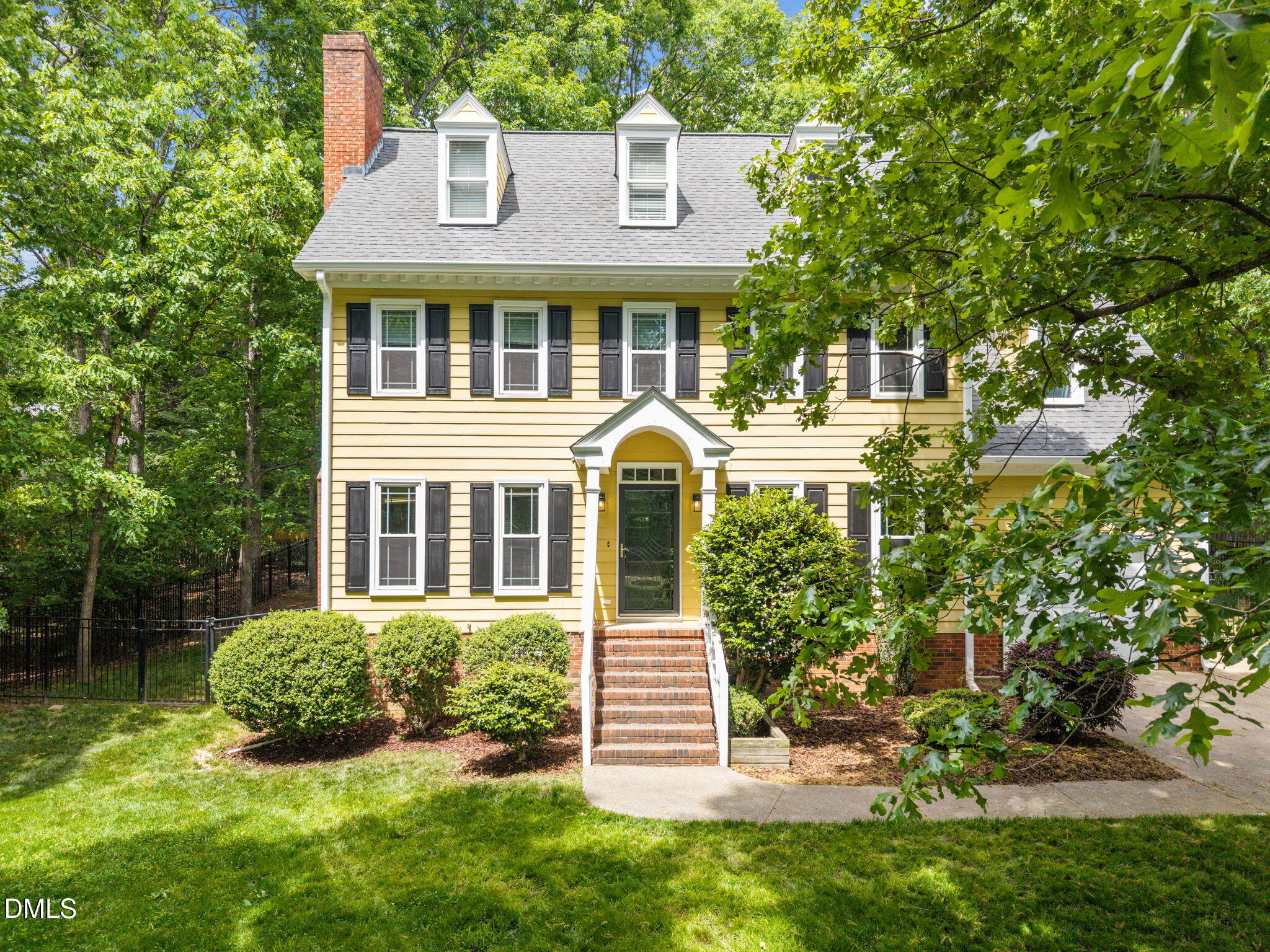 8221 Harps Mill Road Raleigh, NC 27615 - Photo 2 of 46 a front view of a house with a yard