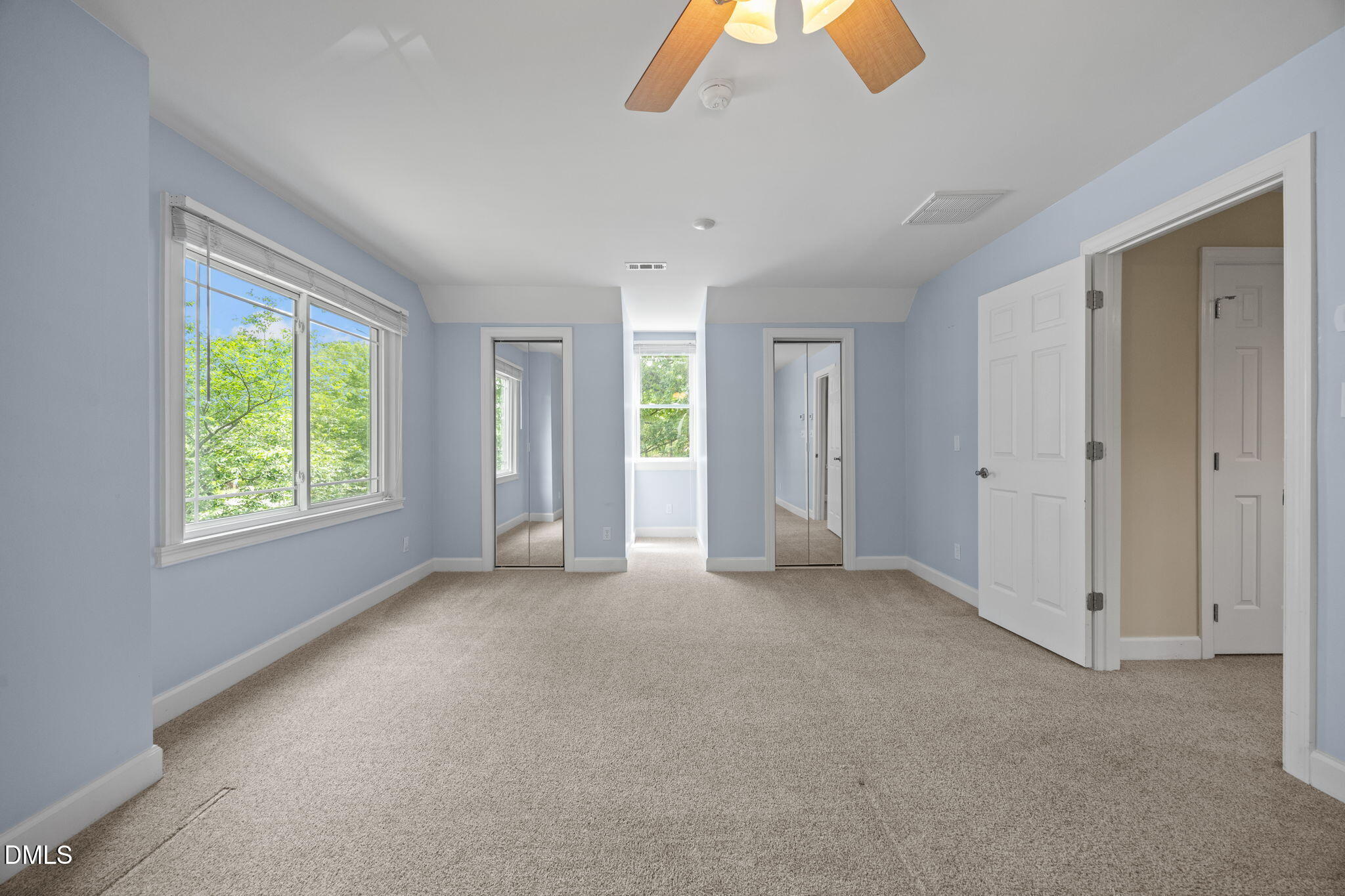 8221 Harps Mill Road Raleigh, NC 27615 - Photo 30 of 46 an empty room with closet and windows