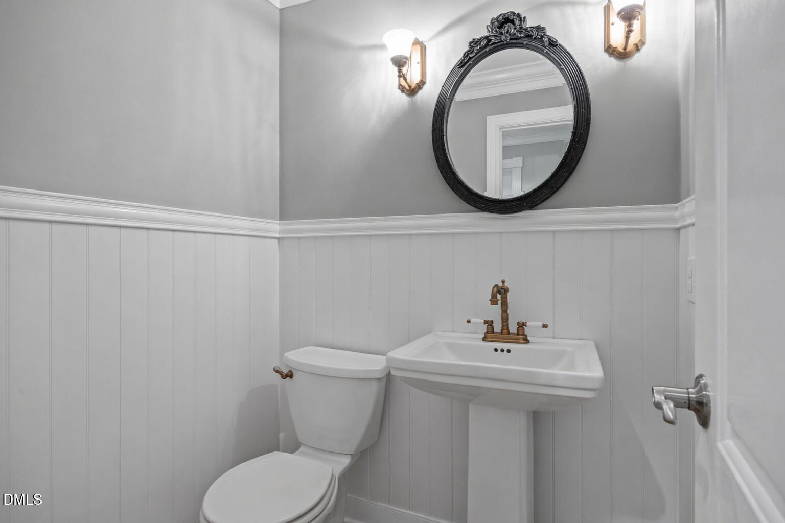 8221 Harps Mill Road Raleigh, NC 27615 - Photo 38 of 46 a bathroom with a sink mirror and toilet