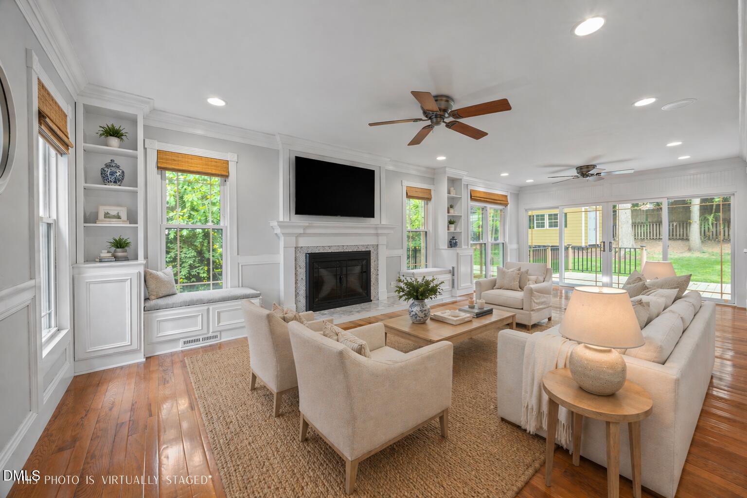 8221 Harps Mill Road Raleigh, NC 27615 - Photo 3 of 46 a living room with furniture a flat screen tv and a fireplace