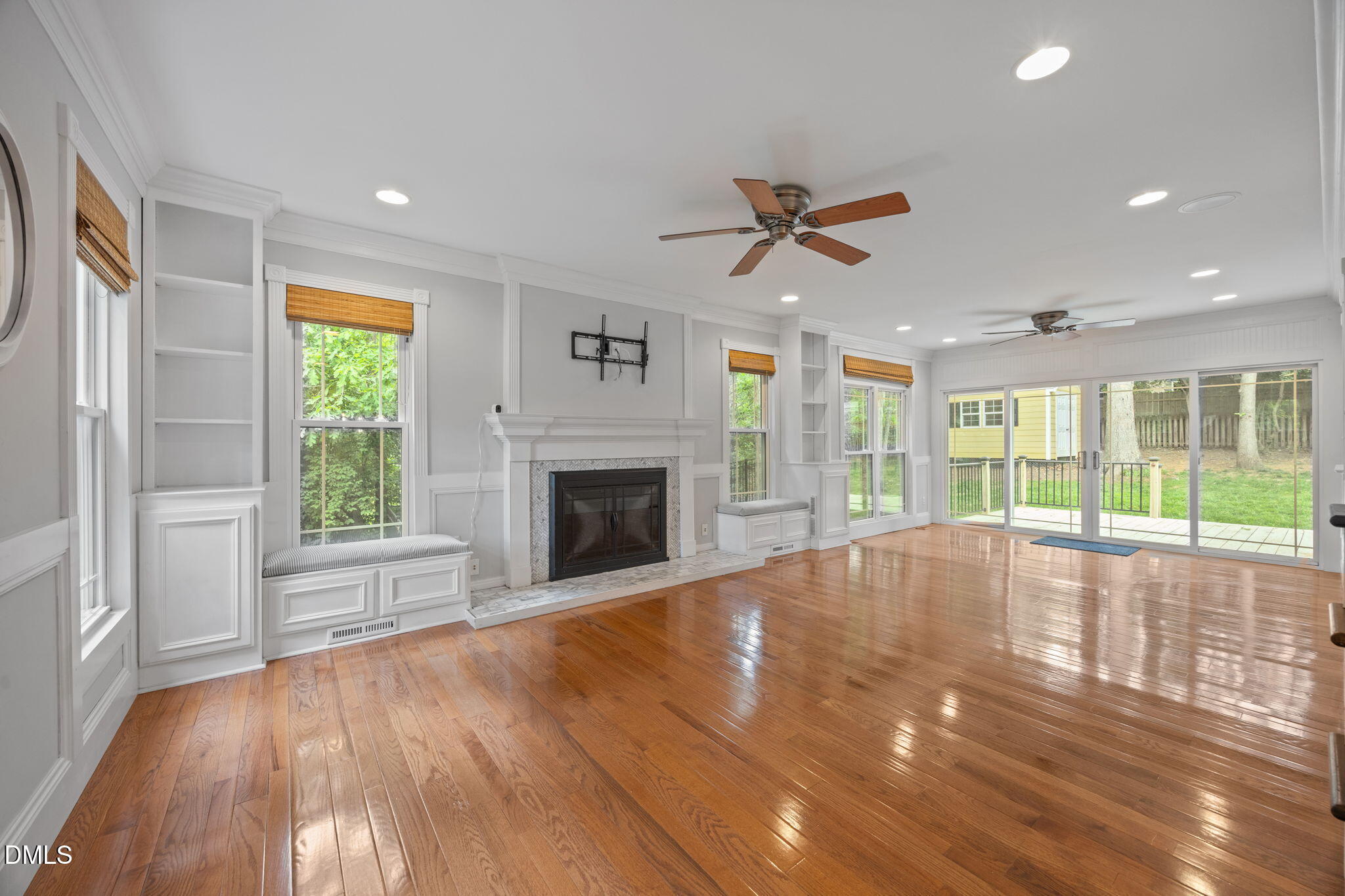 8221 Harps Mill Road Raleigh, NC 27615 - Photo 6 of 46 a view of empty room with wooden floor and fan