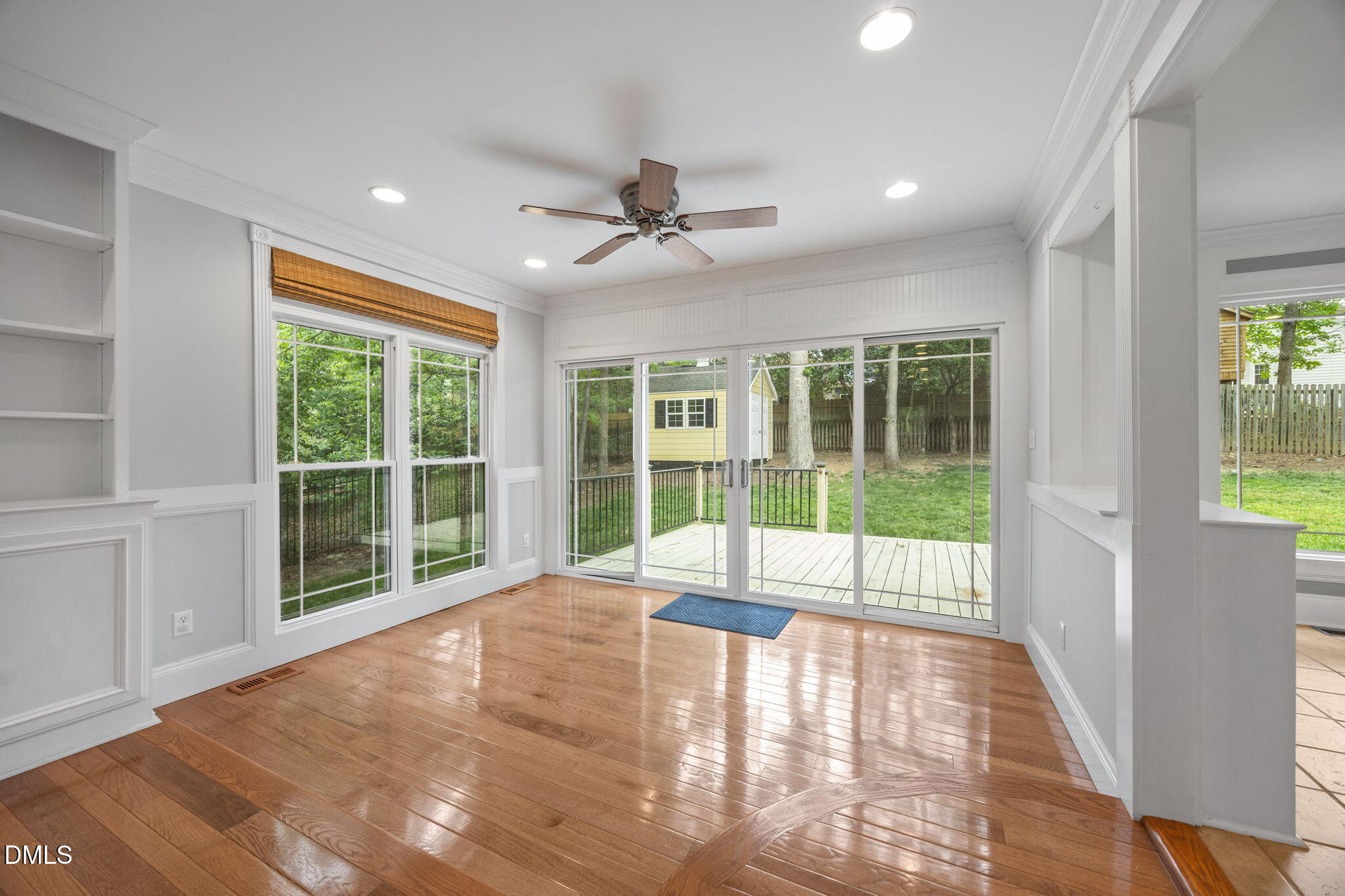 8221 Harps Mill Road Raleigh, NC 27615 - Photo 9 of 46 a view of an empty room with wooden floor and a window