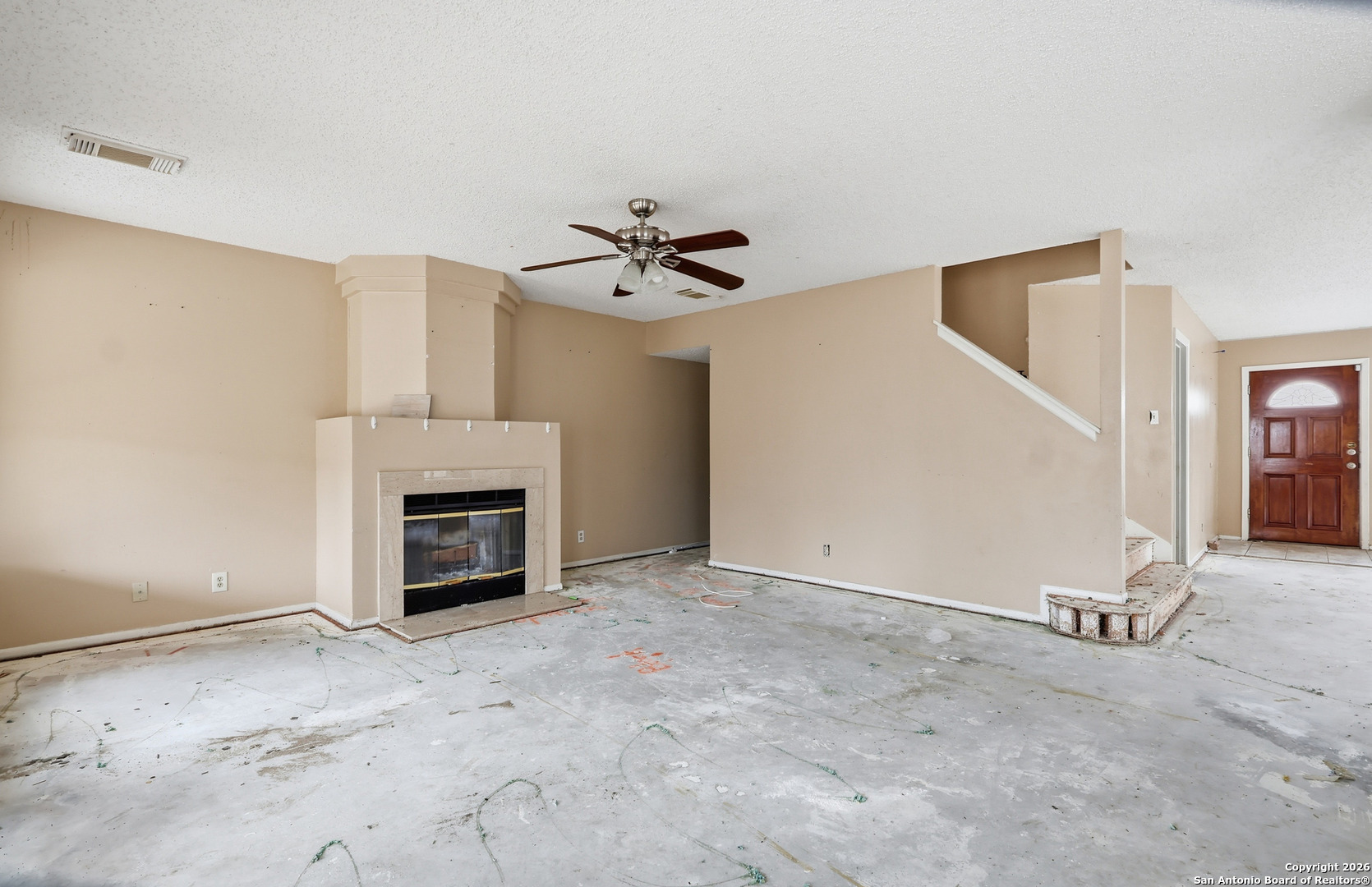 8264 Longhorn Ridge Drive Converse, TX 78109 - Photo 4 of 16 an empty room with fireplace and ceiling fan