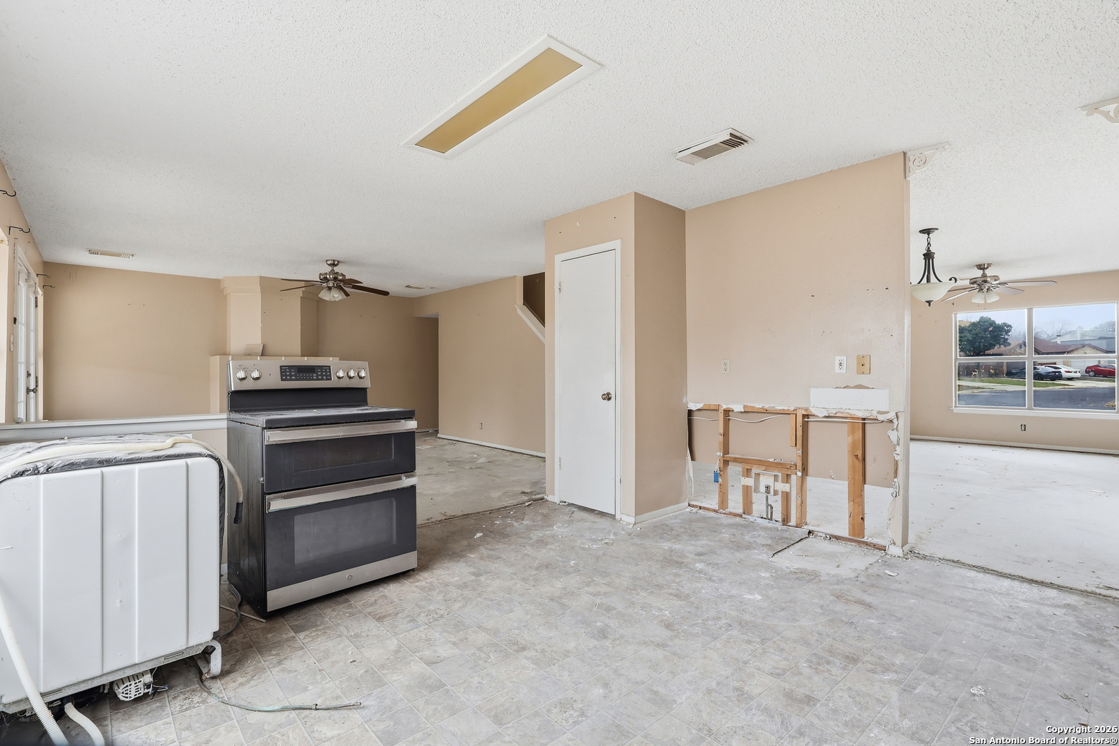 8264 Longhorn Ridge Drive Converse, TX 78109 - Photo 7 of 16 a kitchen with granite countertop a refrigerator and a stove top oven