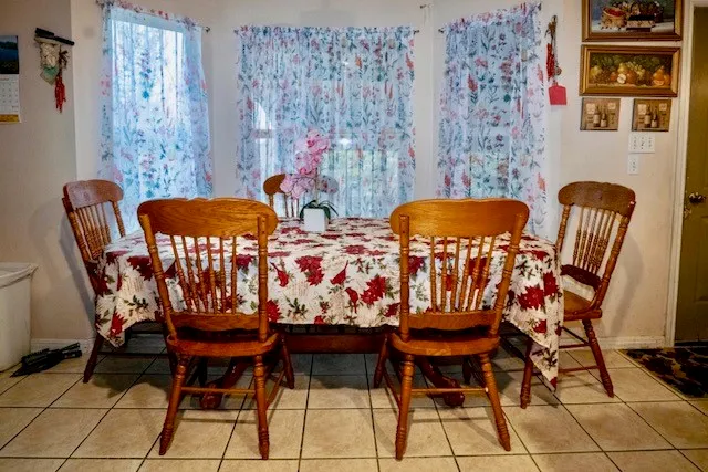 a view of a dining room with furniture and chandelier