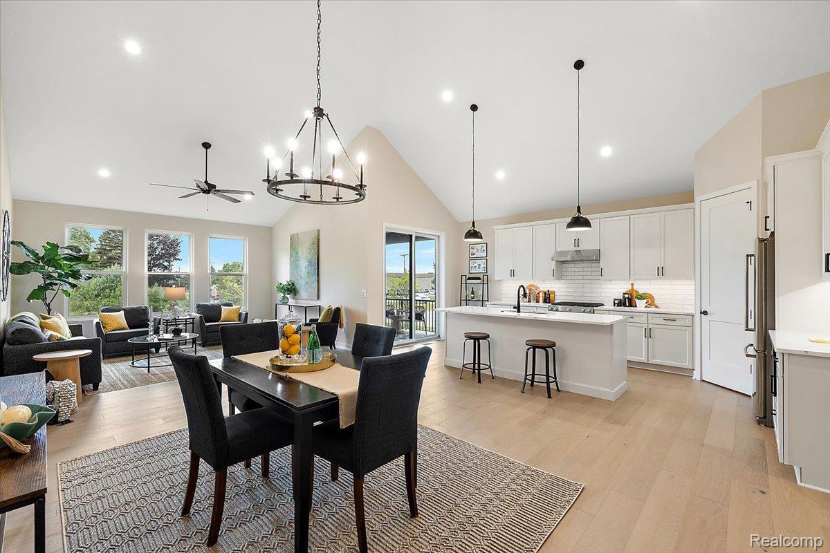 2032 Breckenridge Court, Unit 9 Rochester, MI 48309 - Photo 14 of 39 Dining space featuring a chandelier, light wood-style floors, high vaulted ceiling, ceiling fan, and recessed lighting