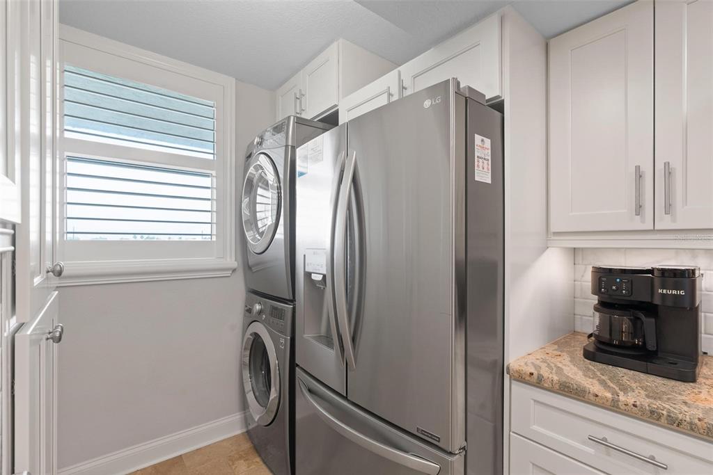 14900 Gulf Boulevard, Unit 202 Madeira Beach, FL 33708 - Photo 11 of 37 a bathroom with a granite countertop shower and a mirror