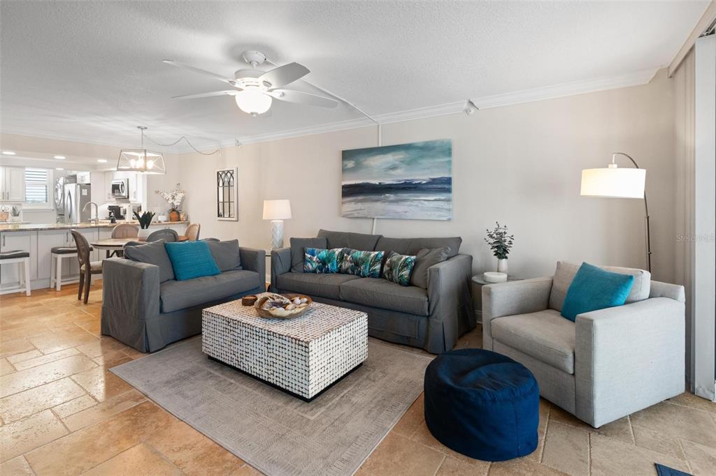 14900 Gulf Boulevard, Unit 202 Madeira Beach, FL 33708 - Photo 14 of 37 a living room with furniture and a chandelier