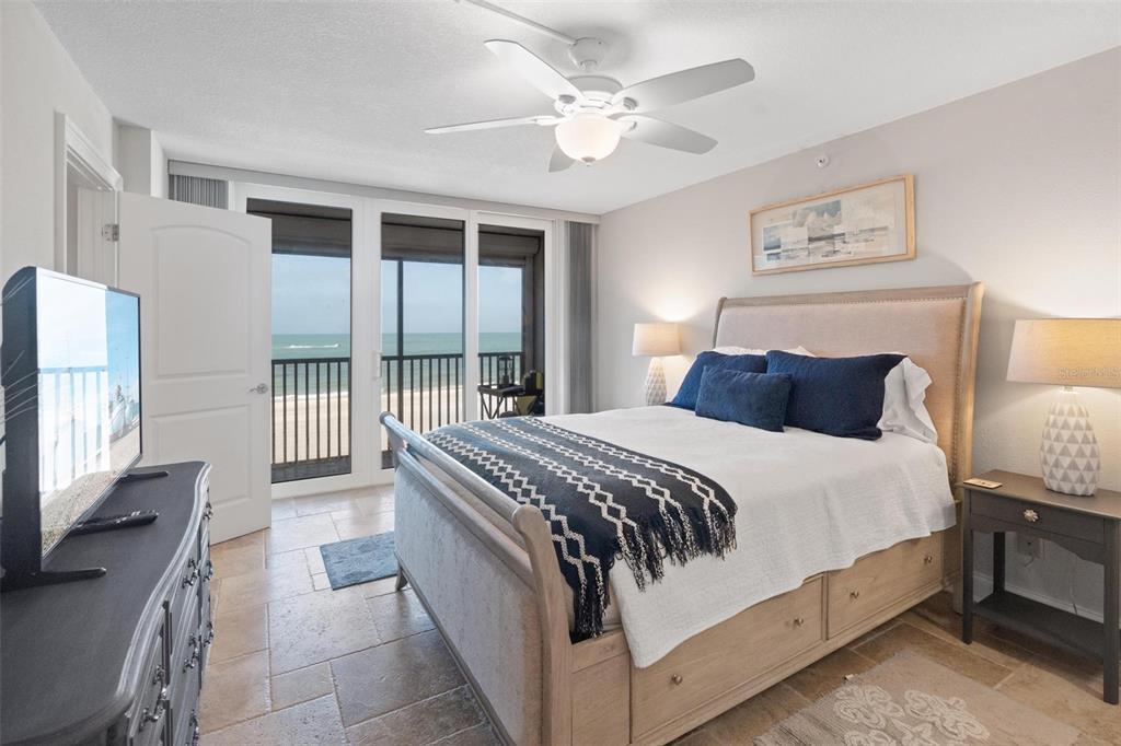 14900 Gulf Boulevard, Unit 202 Madeira Beach, FL 33708 - Photo 15 of 37 a bedroom with a bed a window and dresser