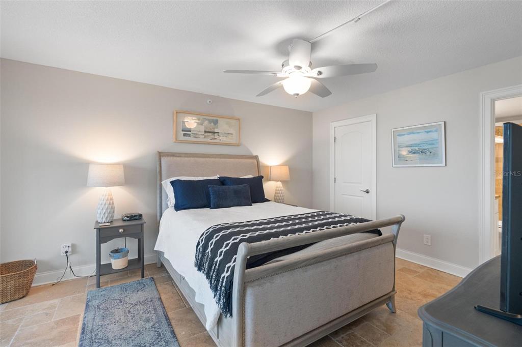 14900 Gulf Boulevard, Unit 202 Madeira Beach, FL 33708 - Photo 16 of 37 a bedroom with a bed and a chandelier