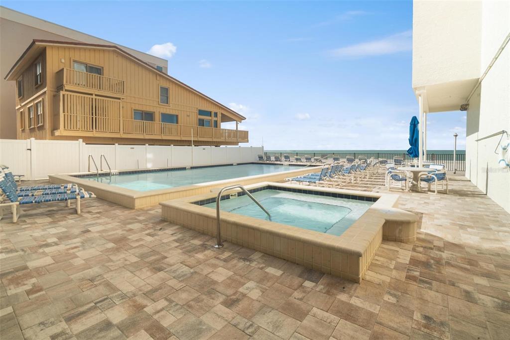 14900 Gulf Boulevard, Unit 202 Madeira Beach, FL 33708 - Photo 27 of 37 a view of a swimming pool with a lounge chairs
