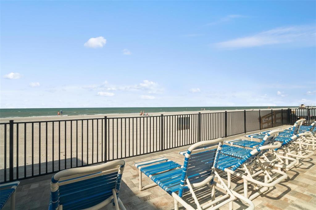 14900 Gulf Boulevard, Unit 202 Madeira Beach, FL 33708 - Photo 29 of 37 a balcony with wooden floor