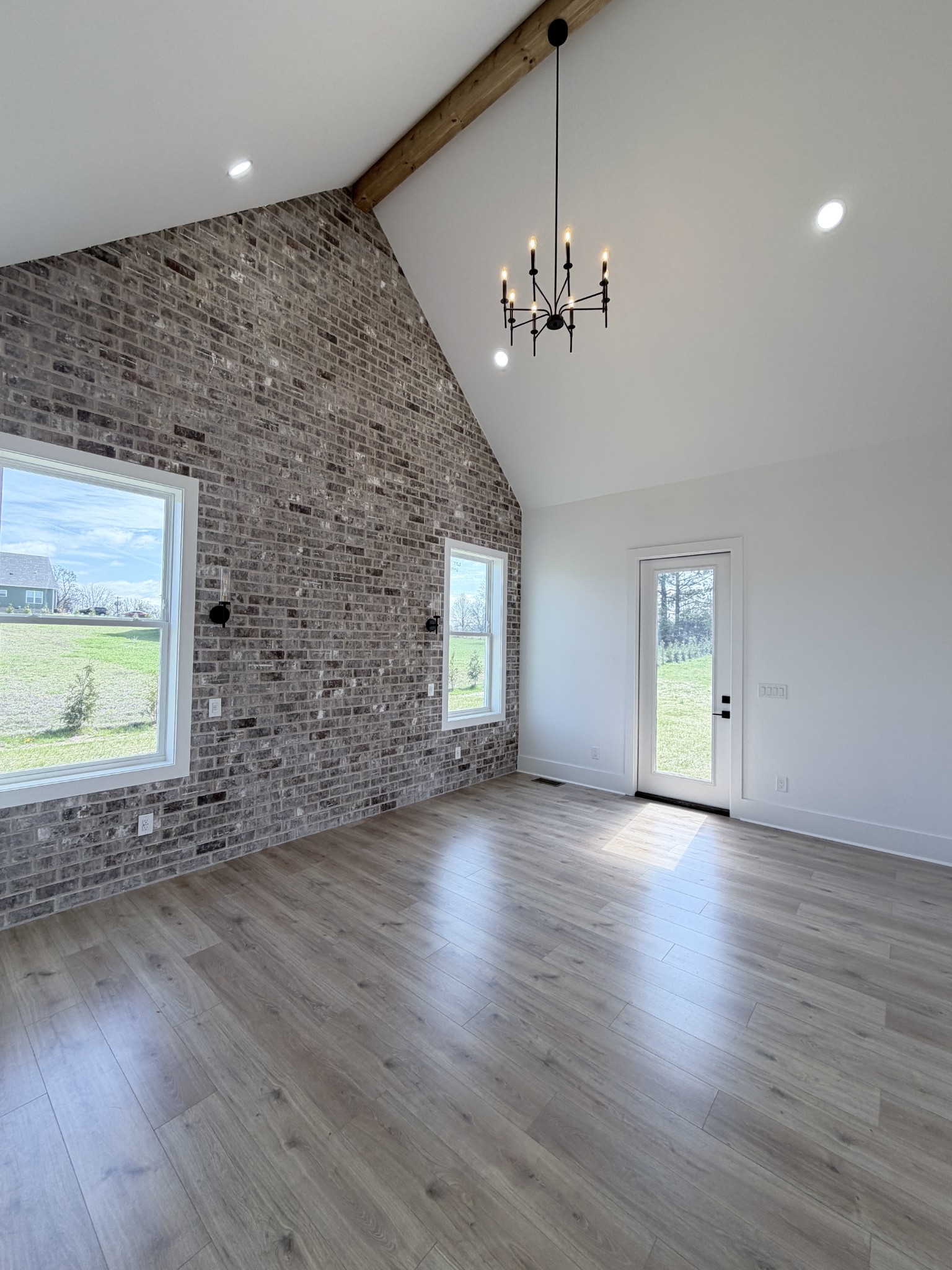 6447 Hopewell Road Springfield, TN 37172 - Photo 20 of 61 an empty room with wooden floor chandelier and windows