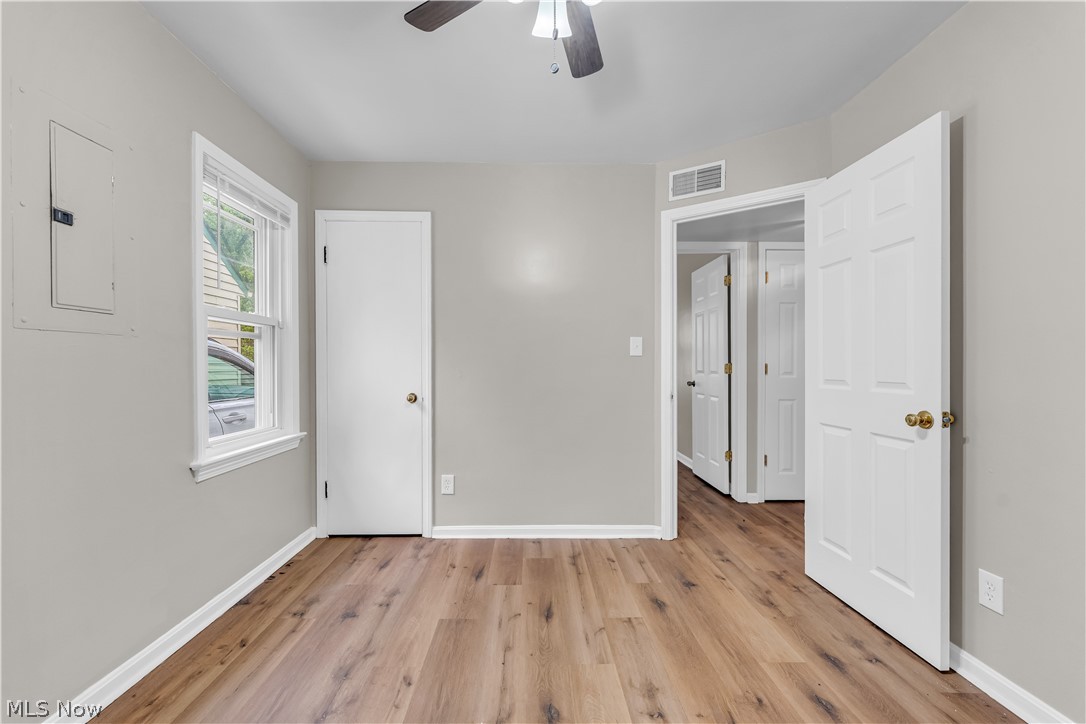 18517 Homeway Road Cleveland, OH 44135 - Photo 17 of 29 Room featuring wood-finish flooring, light grey painted walls, and white trim
