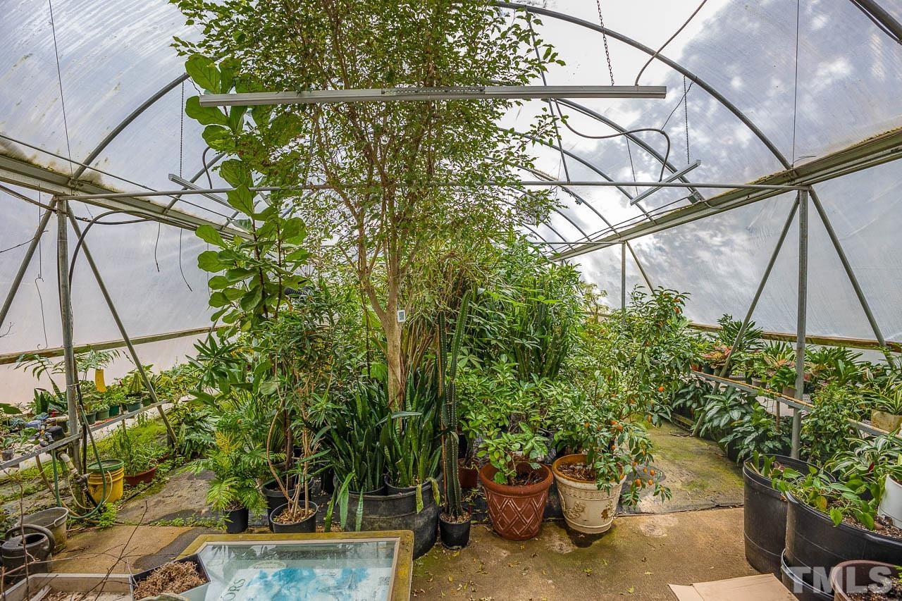 9006 Honeycutt Road Raleigh, NC 27615 - Photo 11 of 54 a view of a backyard with plants and a potted plant