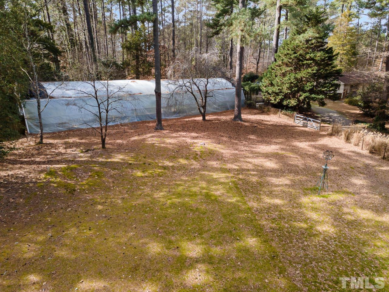 9006 Honeycutt Road Raleigh, NC 27615 - Photo 14 of 54 a view of a yard with a tree
