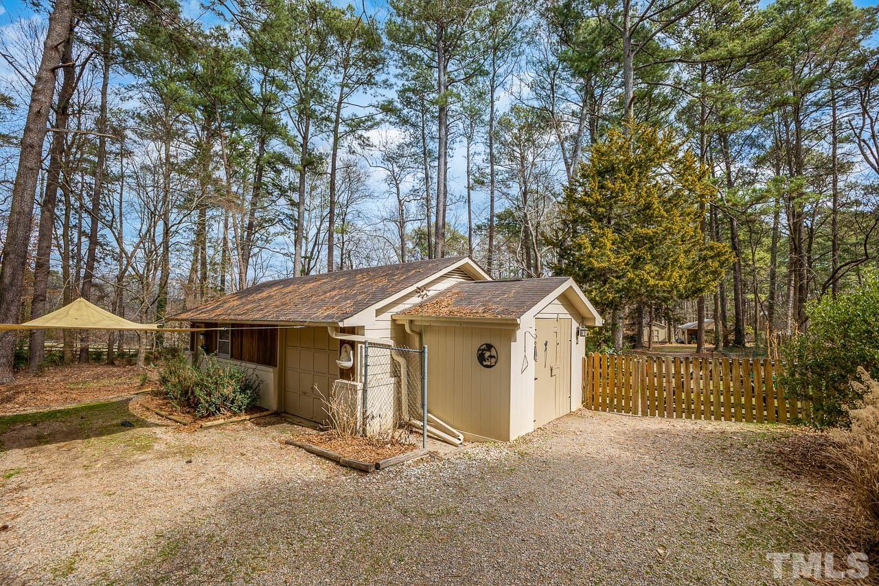 9006 Honeycutt Road Raleigh, NC 27615 - Photo 16 of 54 a front view of a house with a yard and garage