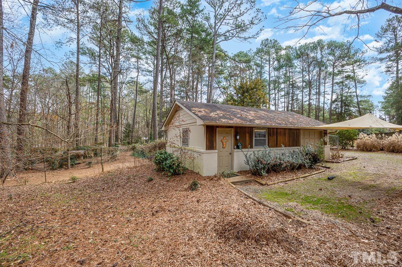 9006 Honeycutt Road Raleigh, NC 27615 - Photo 17 of 54 a front view of a house with a yard