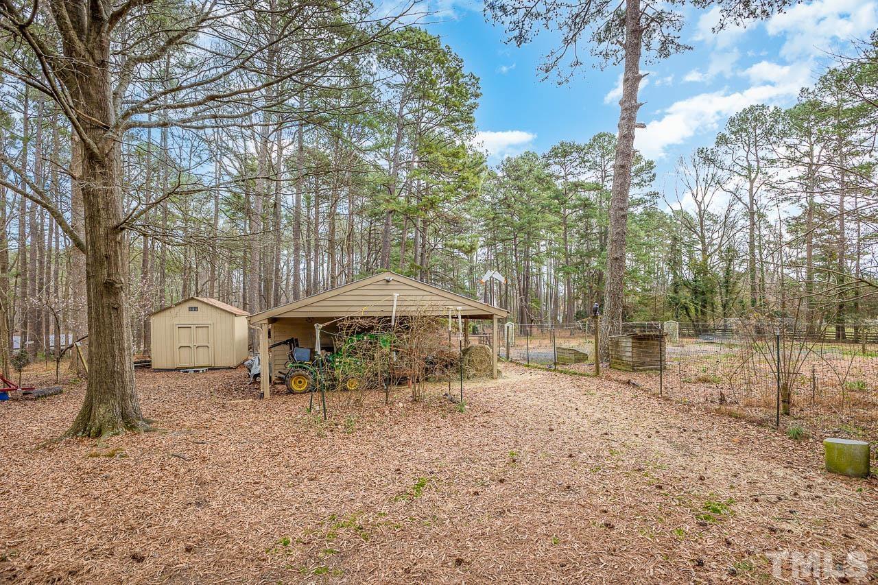 9006 Honeycutt Road Raleigh, NC 27615 - Photo 18 of 54 a backyard of a house with barbeque oven and outdoor seating