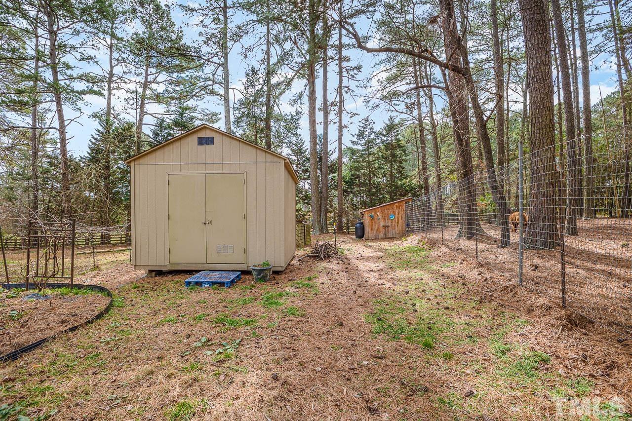9006 Honeycutt Road Raleigh, NC 27615 - Photo 22 of 54 a view of a house with a yard and tree s