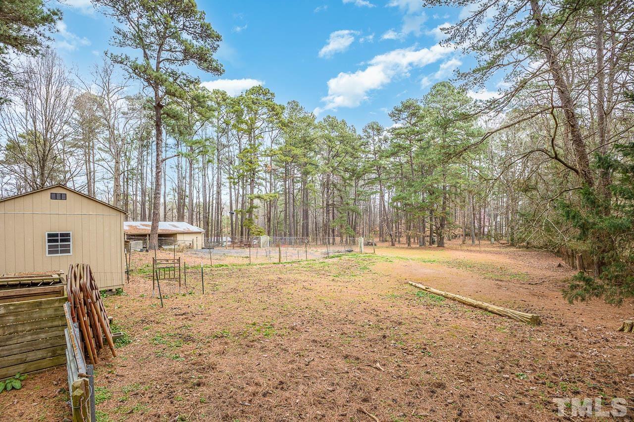 9006 Honeycutt Road Raleigh, NC 27615 - Photo 23 of 54 a view of a house with backyard and a tree