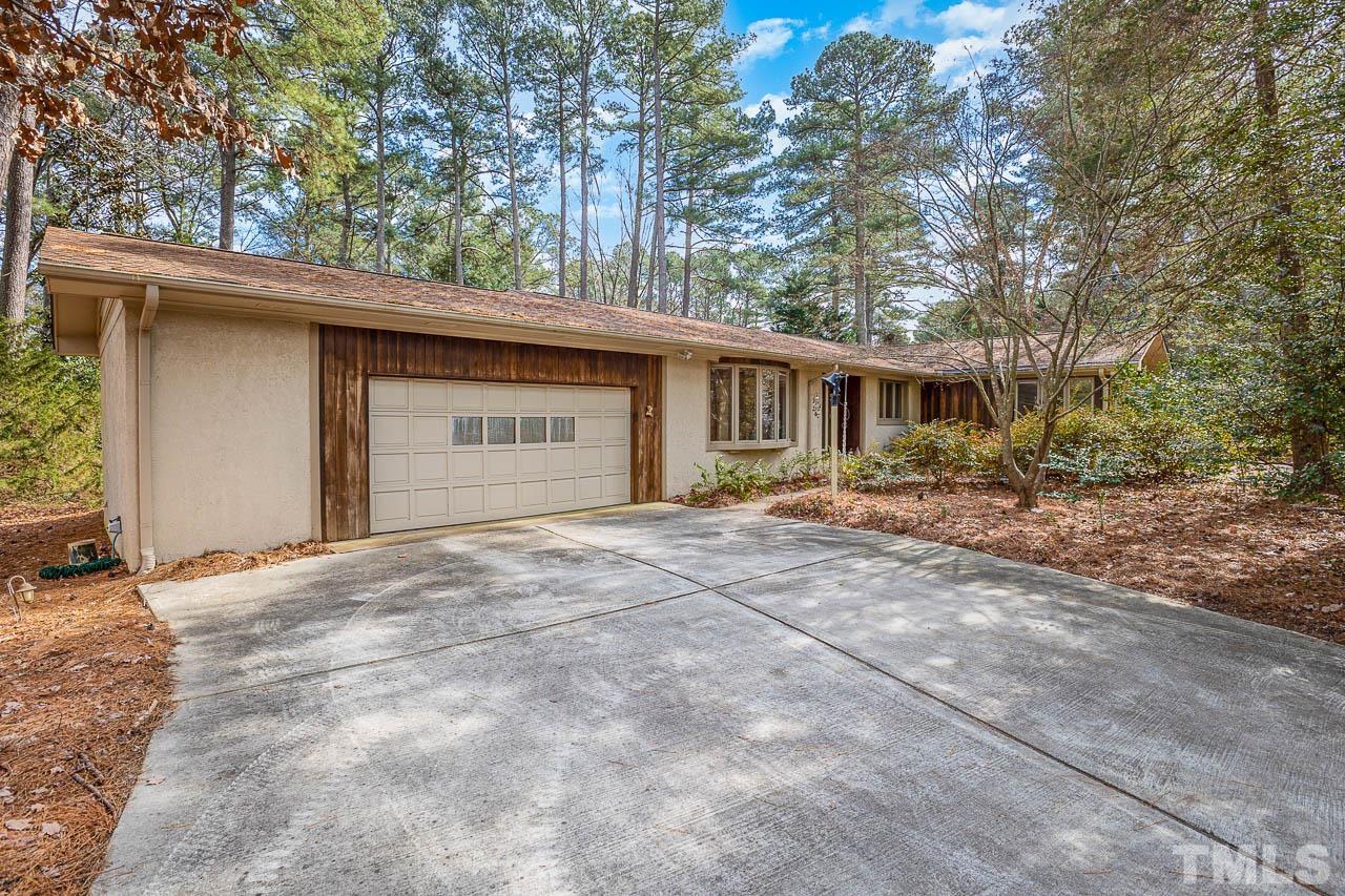 9006 Honeycutt Road Raleigh, NC 27615 - Photo 34 of 54 a front view of house with yard and trees around